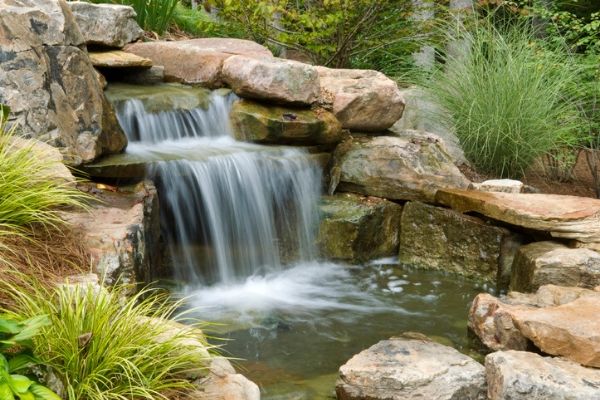 Waterfall installed in backyard garden.