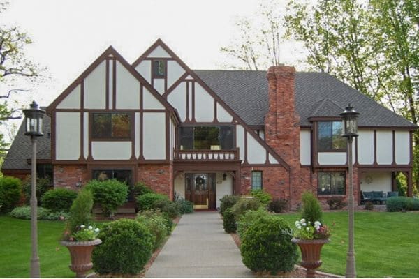  Clean green grass in front of a brick home.