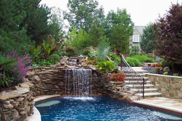 Pool with a rock and stone retaining walls on each side.