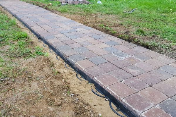 Gravel to grey pavers on front walkway.