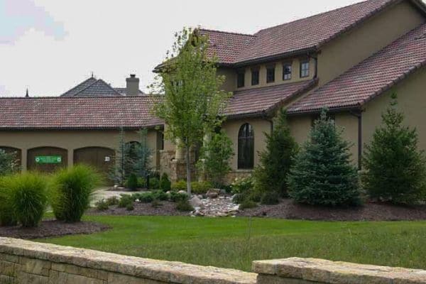  Freshly cut grass with a retaining wall out front.